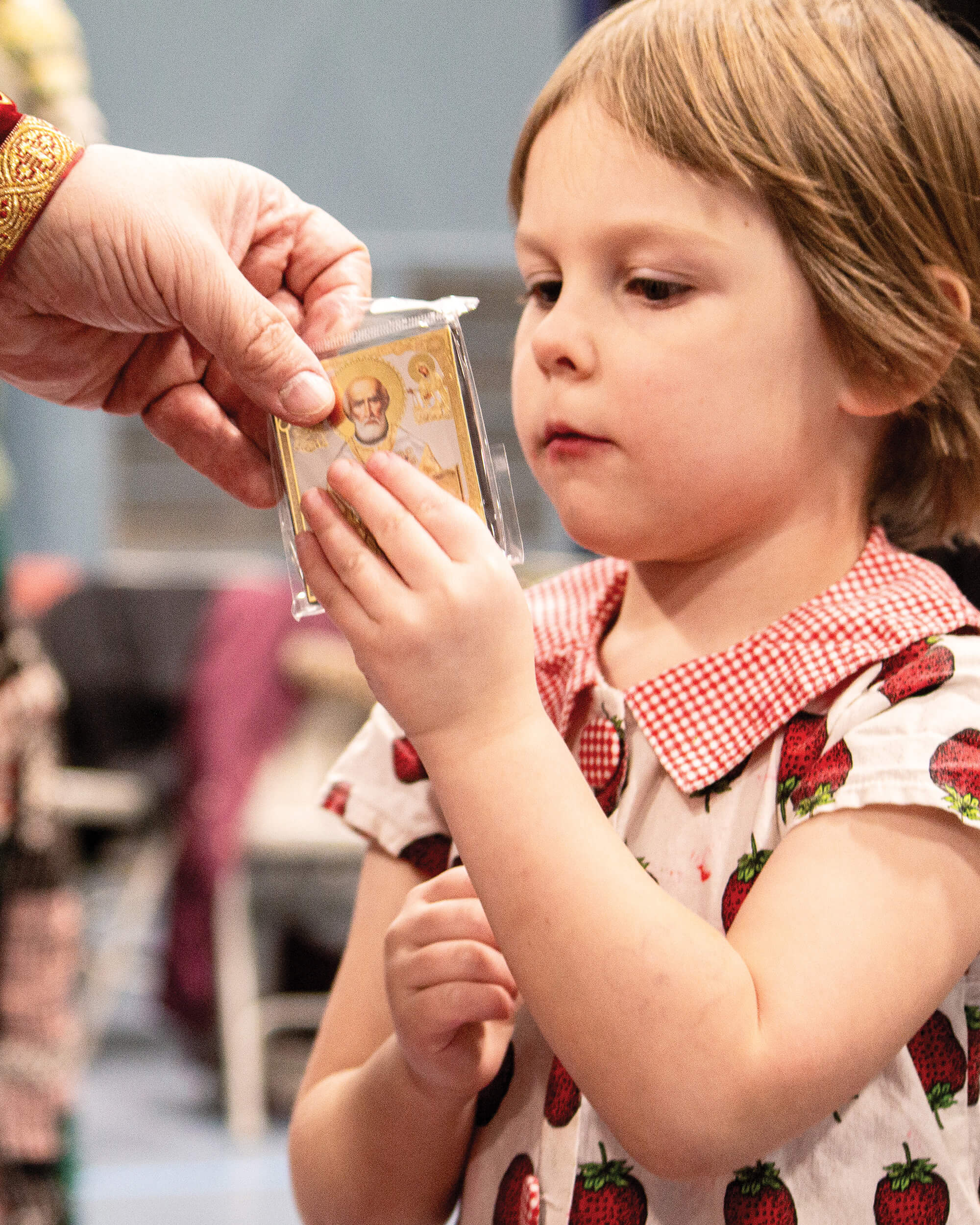 St. Tikhon's Seminary Community Children's Involvement icon being handed to a child.